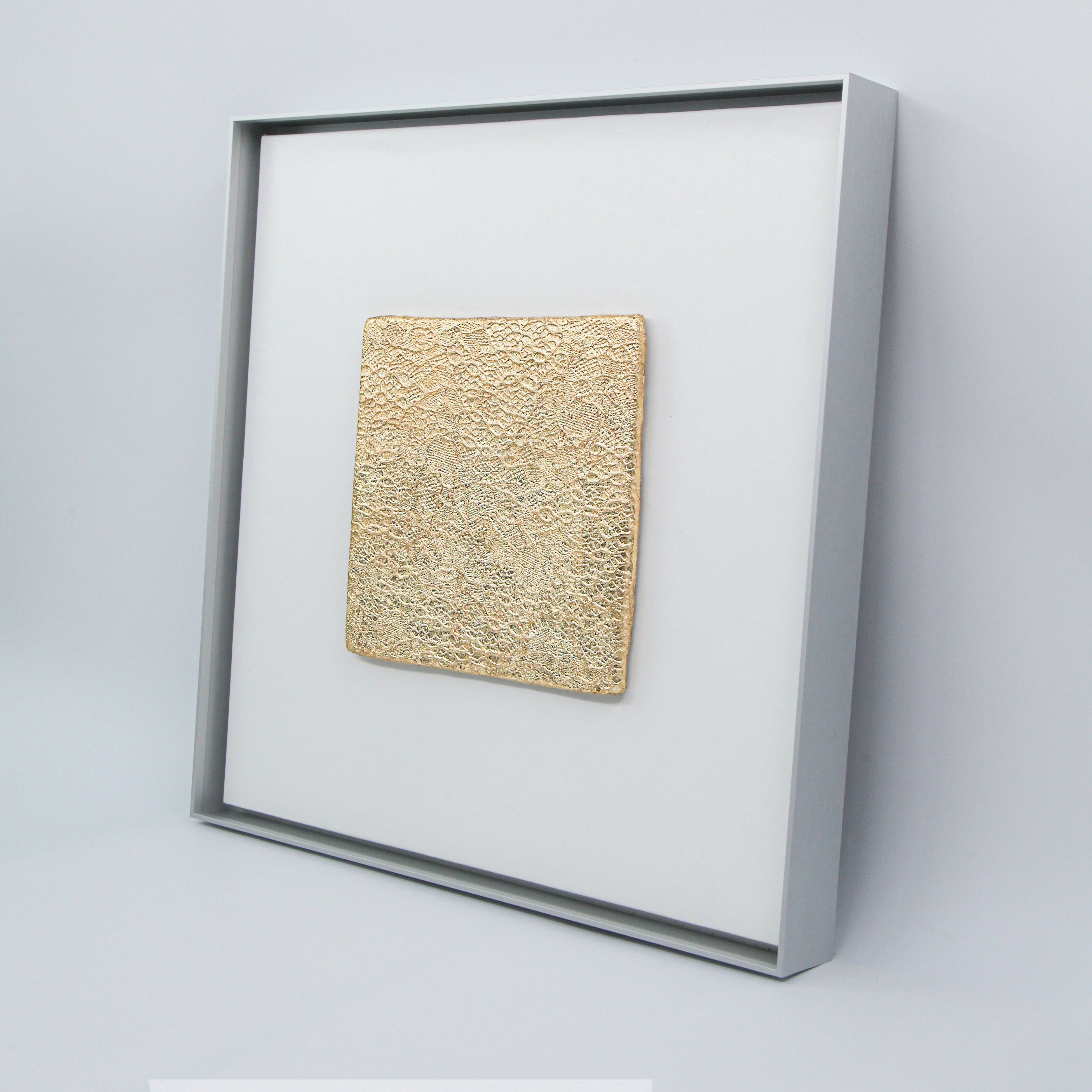 Tendril — Gilded Foil · Aura Frame, full view of a wood element wall art where vines and unfurling leaves are pressed upward by hand from mineral pigment, Eastern Jin Dynasty gilded foil beaten to 0.1 microns weaving through the green-brown terrain like sunlight through a forest canopy.