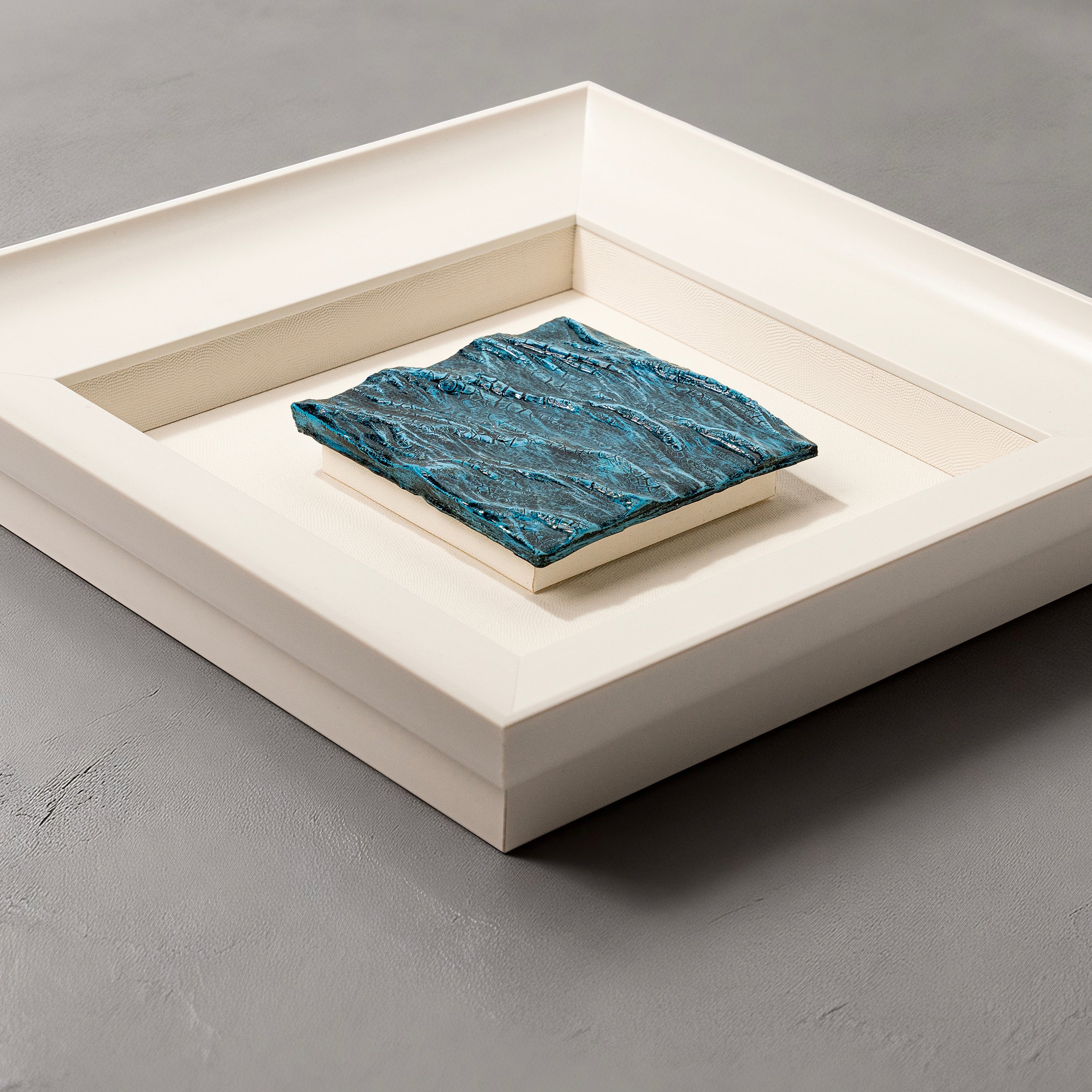 Flat-lay overhead view of Pelagic — Mineral Texture · Aura Frame, capturing the full expanse of its 3D water element mineral terrain — deep navy base rising through layered blue gradations into crystal surface tones, punctuated by hand-worked crackle texture throughout.
