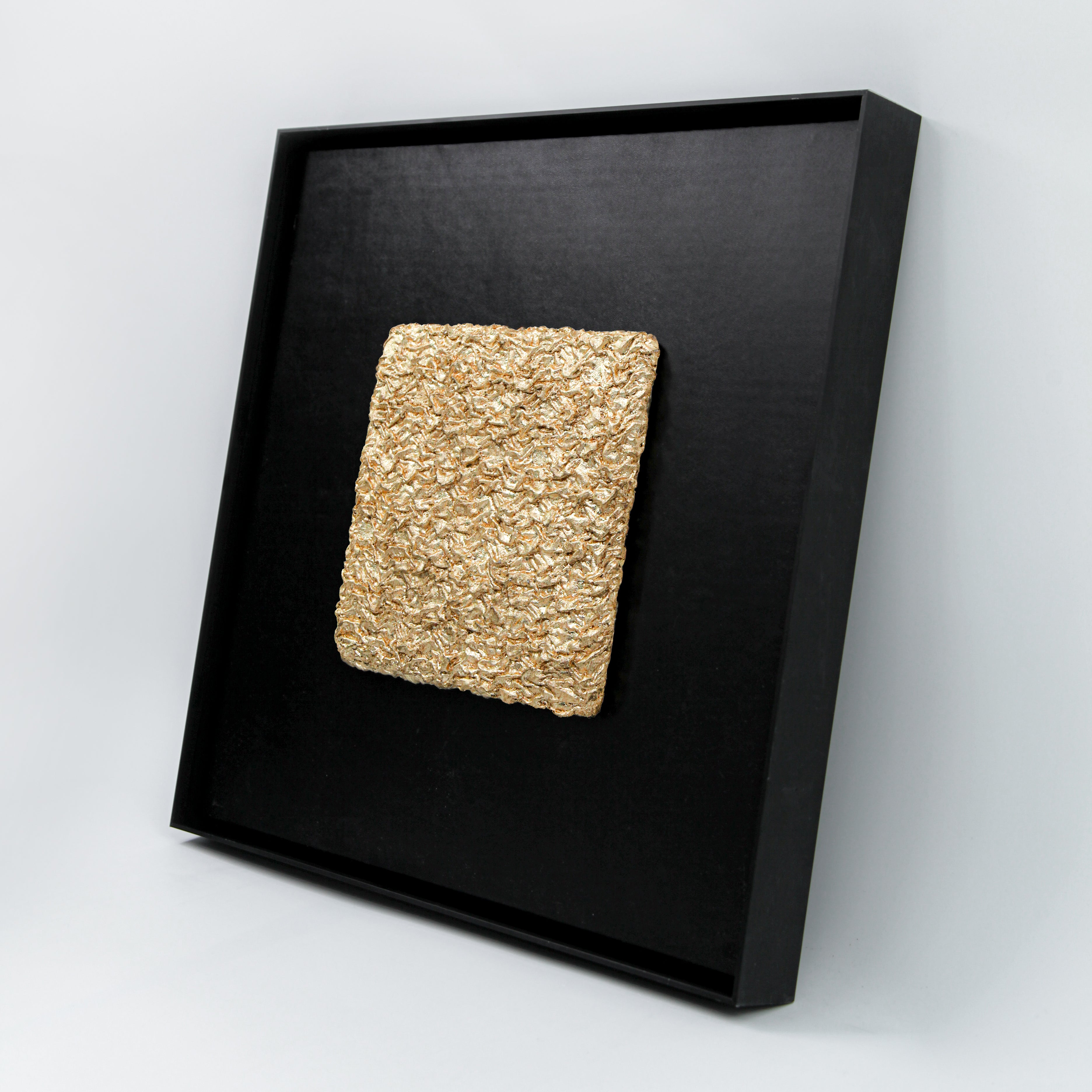 Shan — Gilded Foil · Aura Frame, full view of an earth element wall art where natural mineral pigment is hand-folded into 3D mountain ridgeline relief that reads simultaneously as cracked, desiccated earth, Eastern Jin Dynasty gilded foil surfacing from within the terrain like ore from soil.